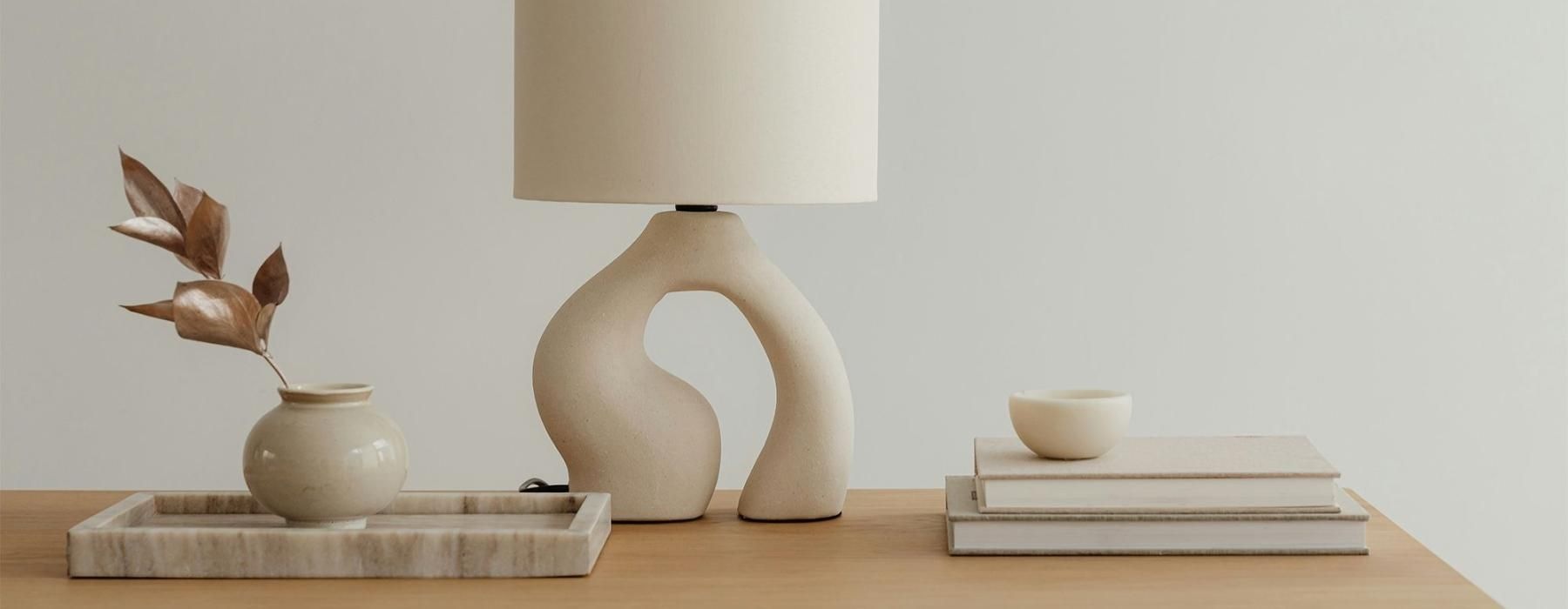 a lamp, stack of books, and decor